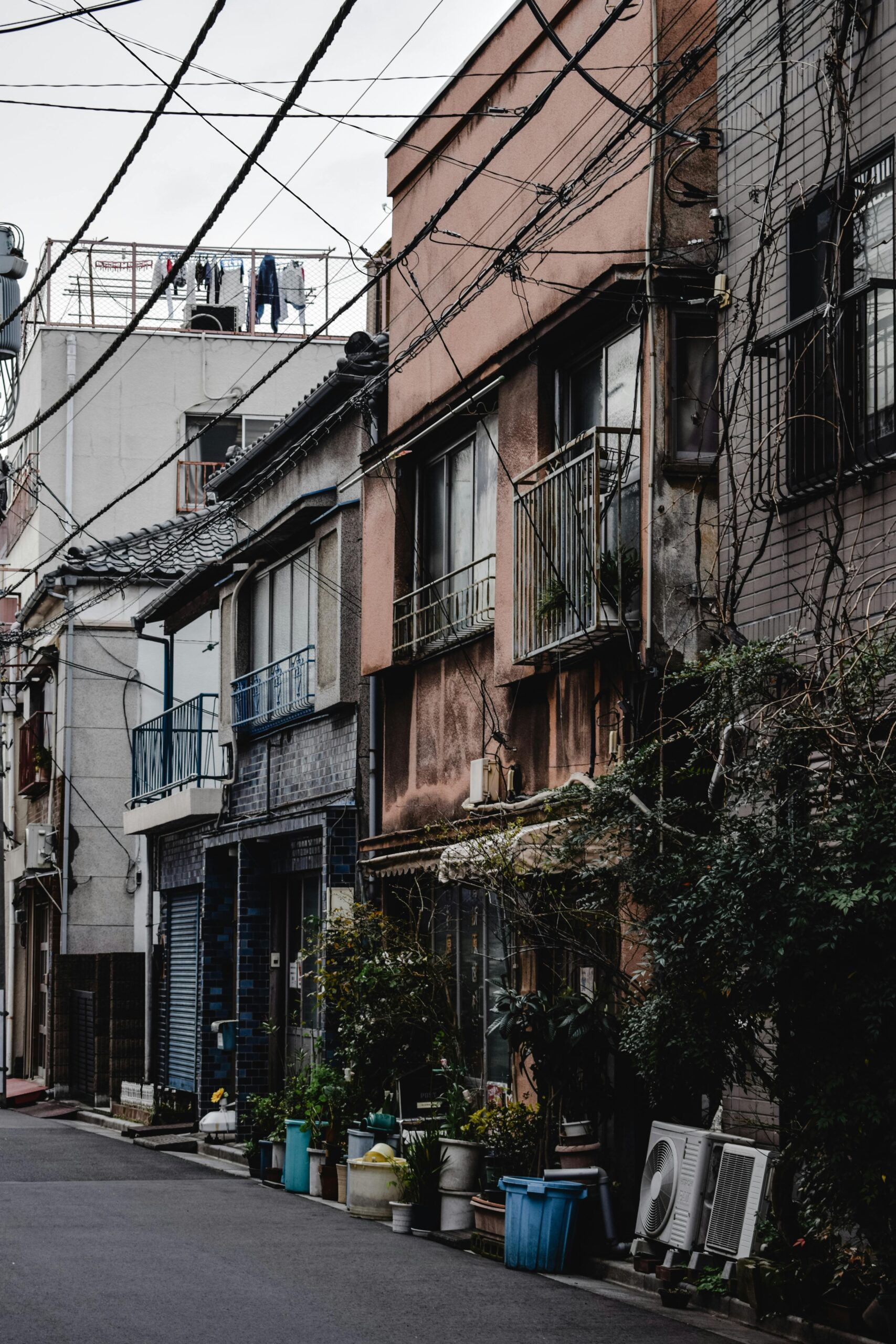 Charming street view of vintage houses and overhead wires in Japan, showcasing urban nostalgia.